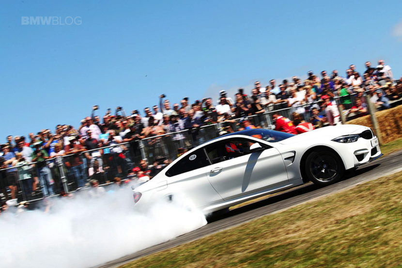 BMW M4 in Alpine White drifts for spectators at Goodwood