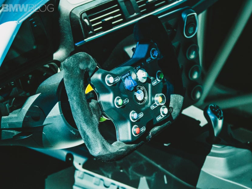 BMW M2 CS Racing interior showing race-spec steering wheel and motorsport controls