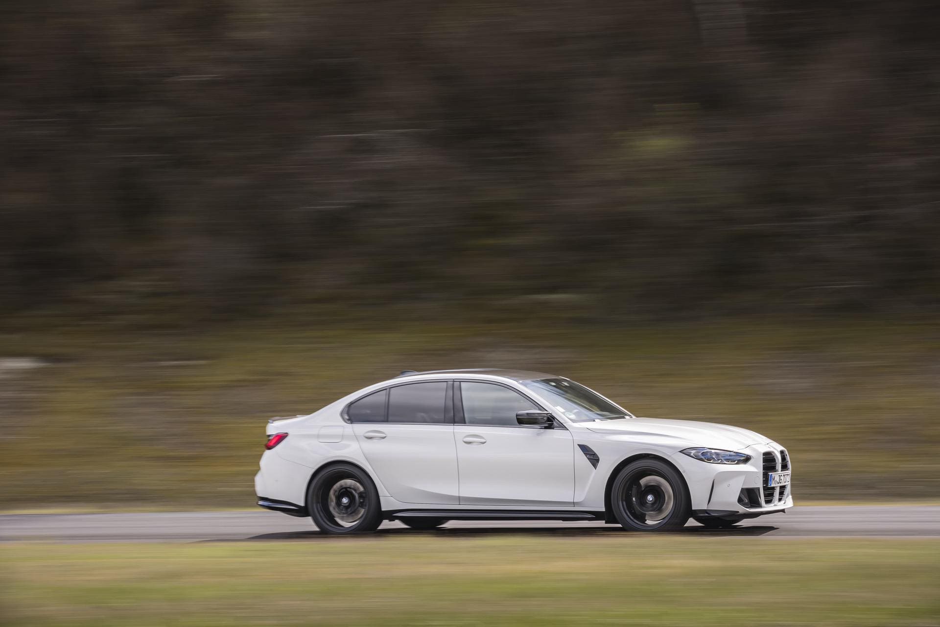 2024 BMW M3 G80 in Alpine White driving on the road