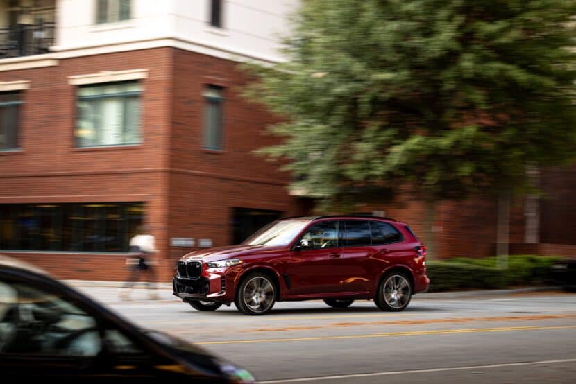 2024 BMW X5 M60i Ruby Red BMW X5 M60i on the road