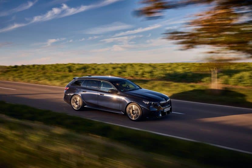 2025 BMW M5 Touring in Frozen Black driving on city street