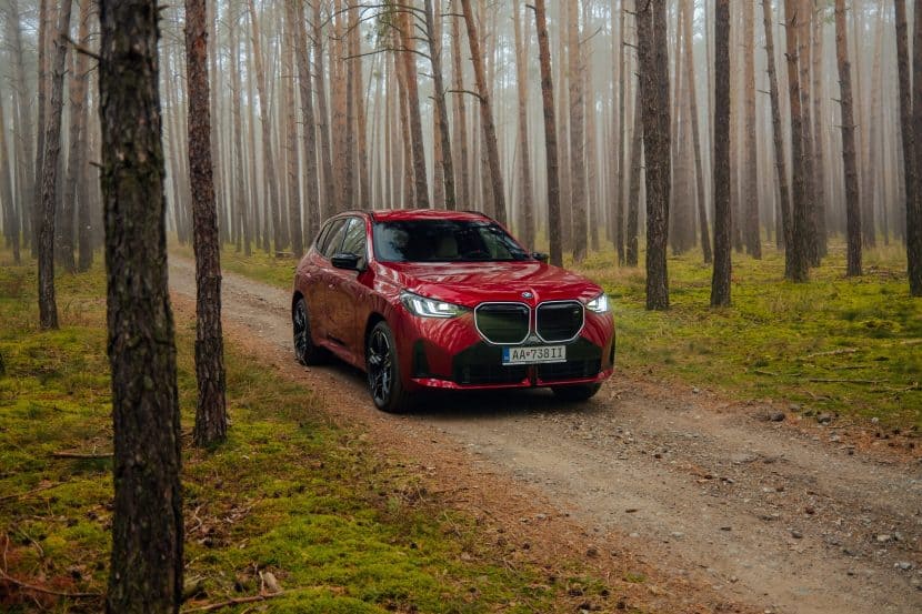 BMW X3 M50 in Fire Red in the woods