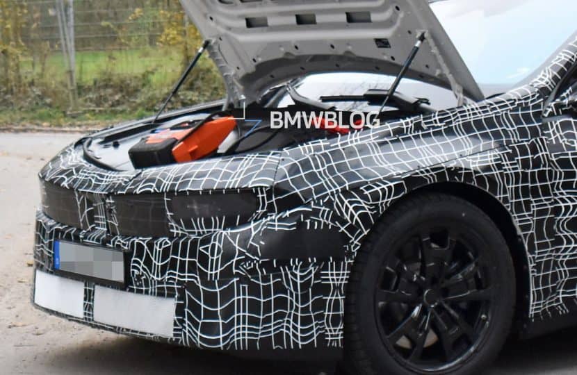 2027 BMW i3 prototype with the hood open showing frunk