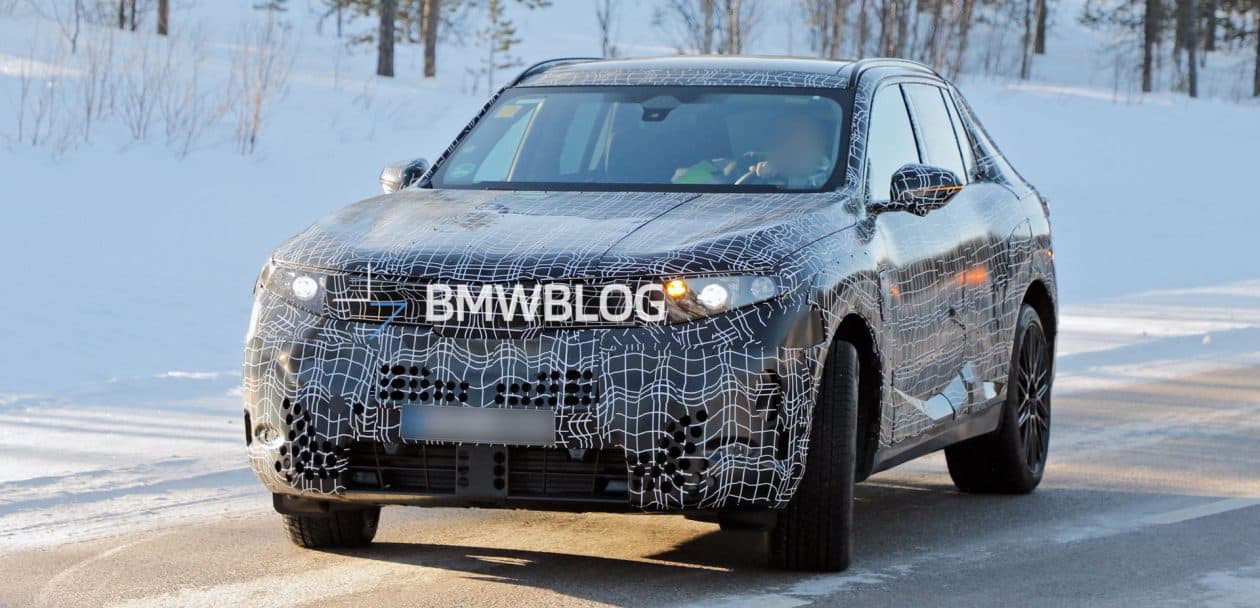 Camouflaged 2027 BMW X5 G65 prototype testing on Autobahn with Vision Neue Klasse–style hidden door handles