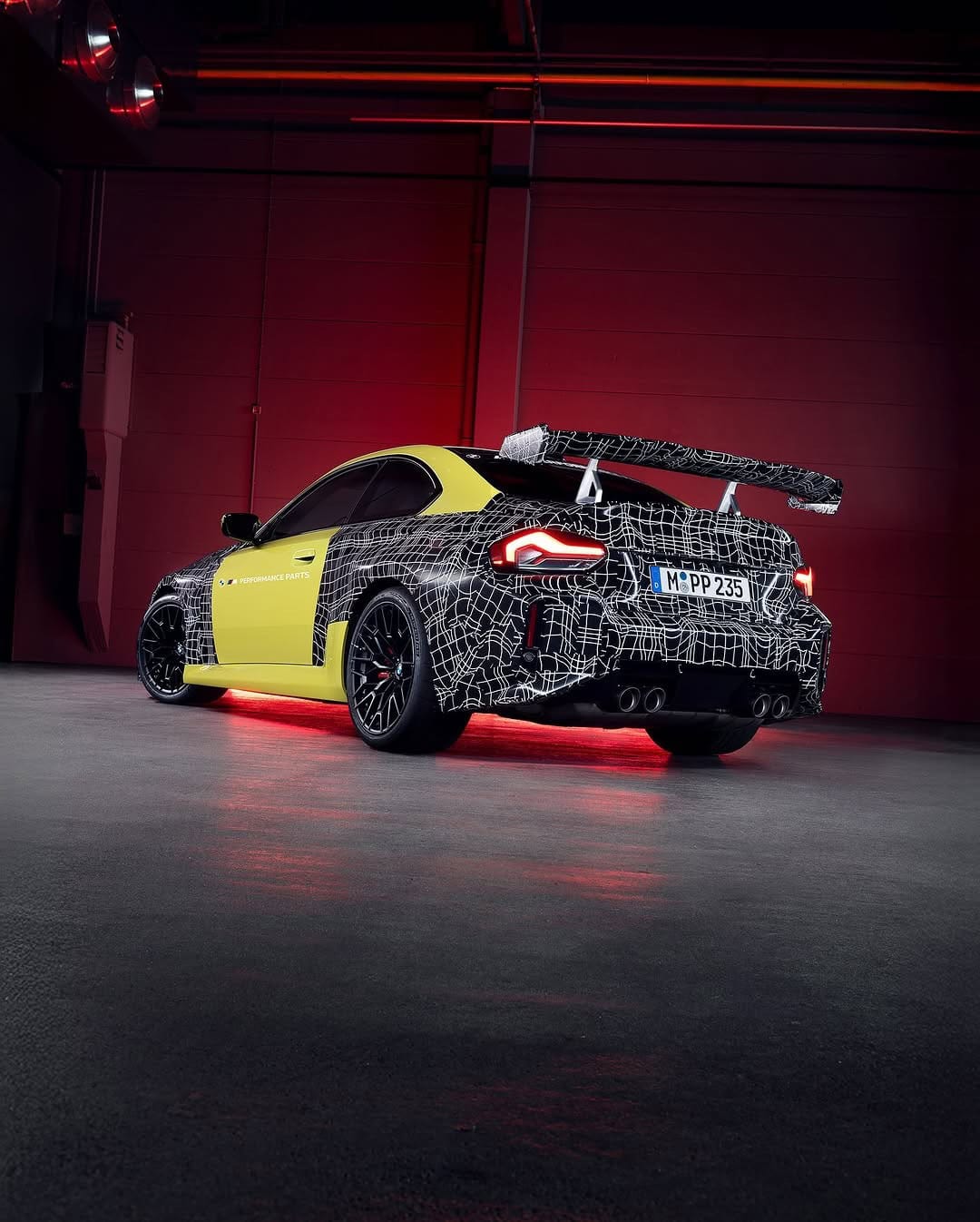 BMW M2 Track Package prototype with large rear wing and camouflaged rear spoiler