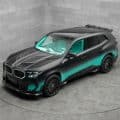 Mansory BMW XM with matte black and turquoise two-tone paint, forged carbon front bumper, and 23-inch wheels
